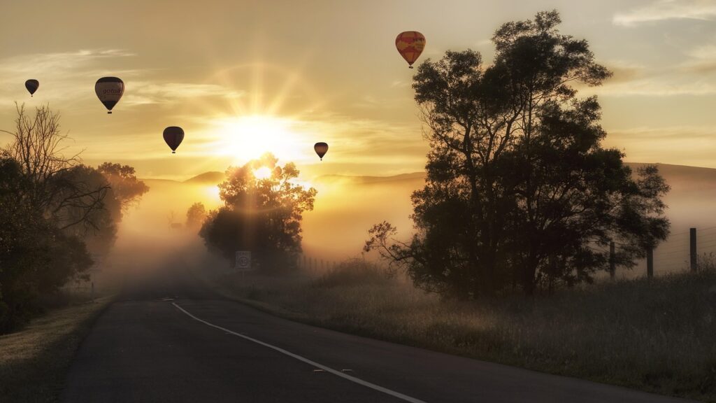 hot air balloons, road, fog, sunrise, morning fog, foggy, haze, mist, misty, street, lane, avenue, hot air balloon ride, landscape, sky, nature, flight, air, float, recreation, flying, aircraft, outdoors, rural, countryside