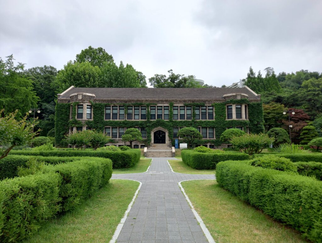 Historic building with ivy facade surrounded by lush greenery in Seoul, South Korea.